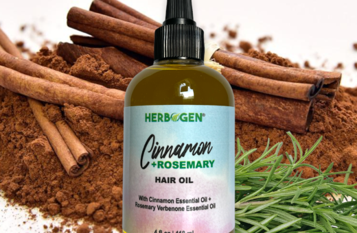 Bottle of 4 oz Cinnamon Rosemary Hair Oil with Cinnamon and rosemary in the background
