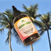 Red Pimento Hair Growth Oil, Jamaican Black Castor Oil, Stinging Nettle Hair Oil 4 oz bottle on decorative palm tree background