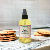 Sugar Cookies Body Oil, 4 ounce bottle with stacks of sugar cookies