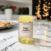 Sugar Cookies Body Oil, 4 ounce bottle with sugar cookies In background